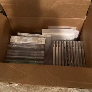 31 plastic CD/DVD blank cases and 34 paper sleeves